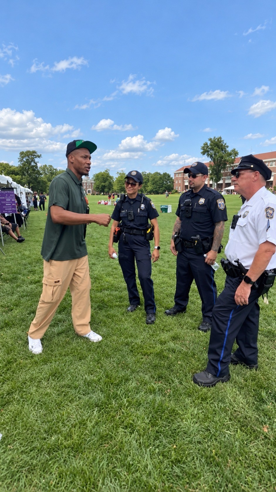 Philly Be Safe representative speaking with public safety officers during a community event